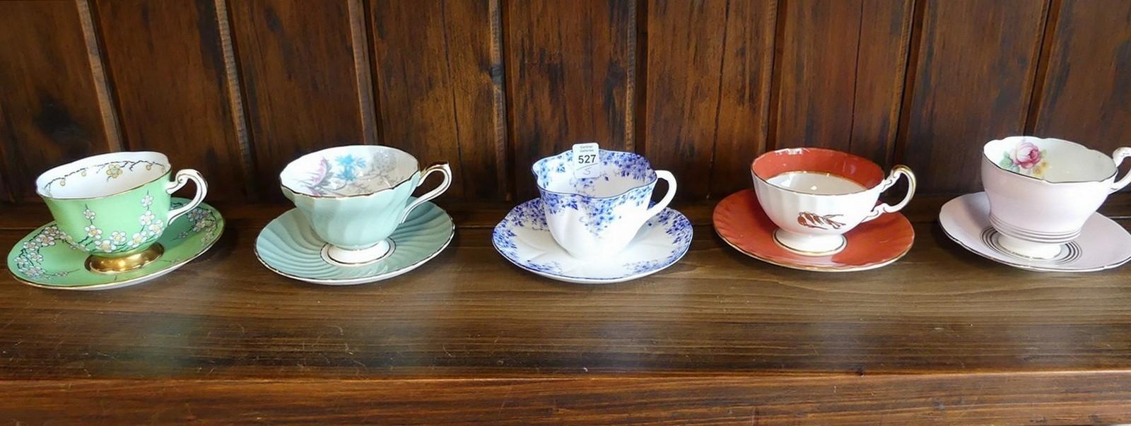 FIVE CUPS AND SAUCERS