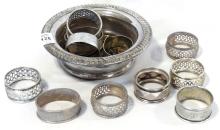 ELEVEN STERLING NAPKIN RINGS AND WINE COASTER