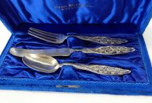 HENRY BIRKS AND COMPANY CHILD'S STERLING CUTLERY SET, RATTLE AND SPOON