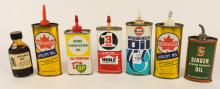 SIX OIL CANS AND BOTTLE