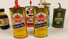 SIX OIL CANS AND BOTTLE