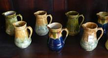 ELEVEN BRANTFORD POTTERY CREAM PITCHERS