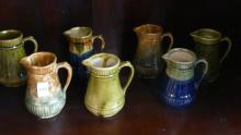 ELEVEN BRANTFORD POTTERY CREAM PITCHERS