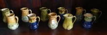 ELEVEN BRANTFORD POTTERY CREAM PITCHERS