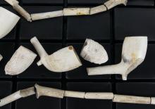 COLLECTION OF CLAY PIPE BOWLS AND STEMS