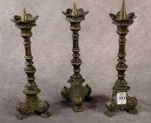 THREE ANTIQUE BRONZE PRICK CANDLESTICKS
