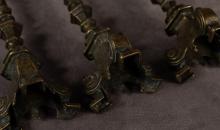 THREE ANTIQUE BRONZE PRICK CANDLESTICKS