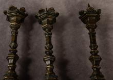 THREE ANTIQUE BRONZE PRICK CANDLESTICKS