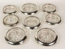 EIGHT STERLING RIMMED COASTERS