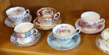 EIGHT CUPS AND SAUCERS