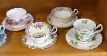 EIGHT CUPS AND SAUCERS
