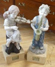 PAIR OF RESIN "CHILD MUSICIAN" SCULPTURES