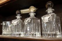 THREE CRYSTAL DECANTERS AND ICE BUCKET