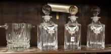 THREE CRYSTAL DECANTERS AND ICE BUCKET