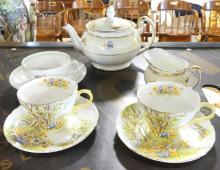 TEAPOT, CREAMER, CUPS AND SAUCERS