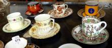 NINE DEMITASSE CUPS AND SAUCERS