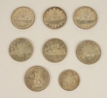 SEVEN CANADIAN SILVER DOLLARS AND HALF DOLLAR