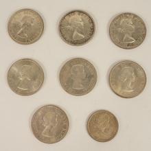 SEVEN CANADIAN SILVER DOLLARS AND HALF DOLLAR