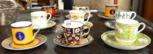 NINE DEMITASSE CUPS AND SAUCERS