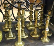FIVE PAIRS OF BRASS CANDLESTICKS