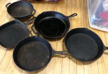 FIVE CAST IRON FRYING PANS