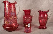 FOUR ANTIQUE CRANBERRY GLASS PITCHERS