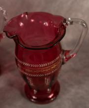 FOUR ANTIQUE CRANBERRY GLASS PITCHERS