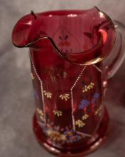 FOUR ANTIQUE CRANBERRY GLASS PITCHERS